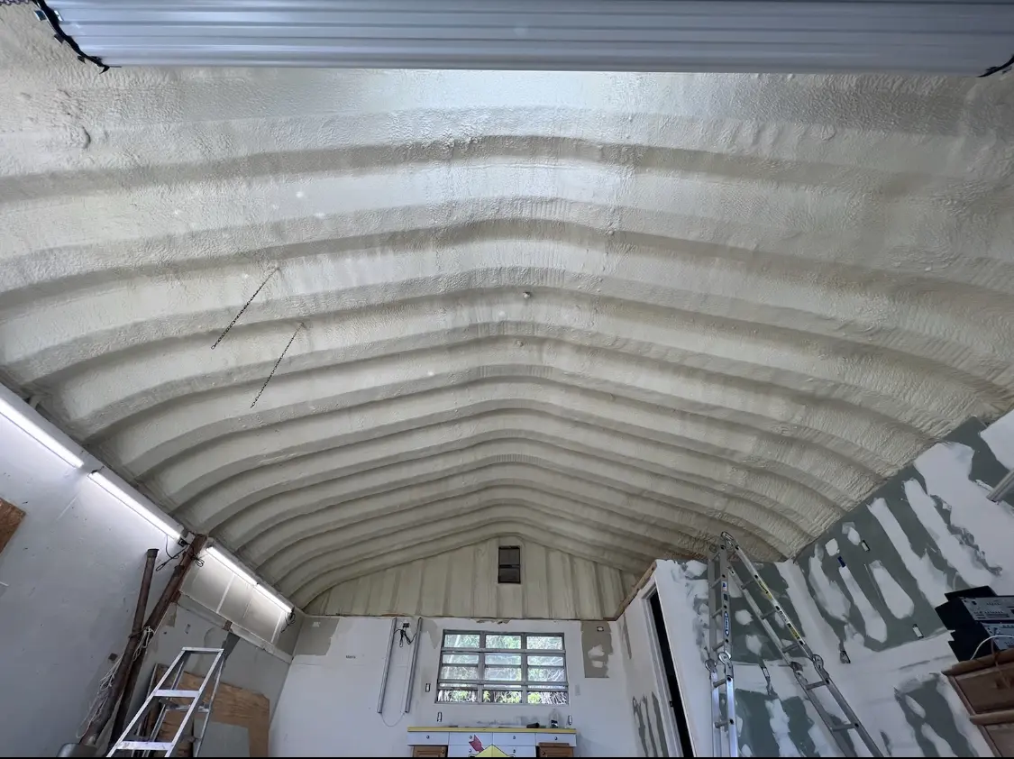 Spray polyurethane foam applied to the underside of a metal roof deck in De Soto